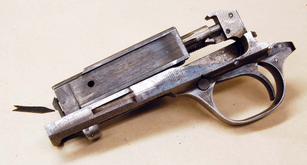 Note how the extractor (arrow) extends out from the breechblock. It will be broken if the breechblock is not pulled back before trying to remove the barrel.